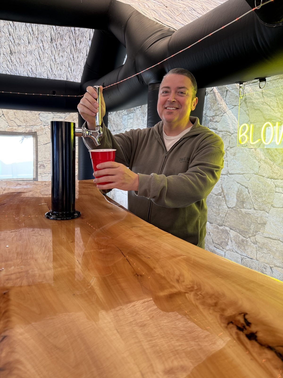 A drink being poured behind the bar